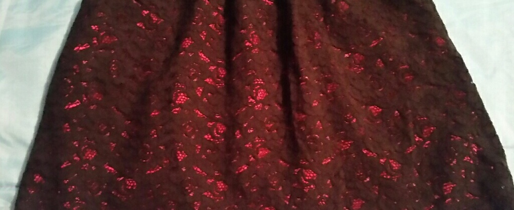 Black lacy type material skirt with red underlayer
